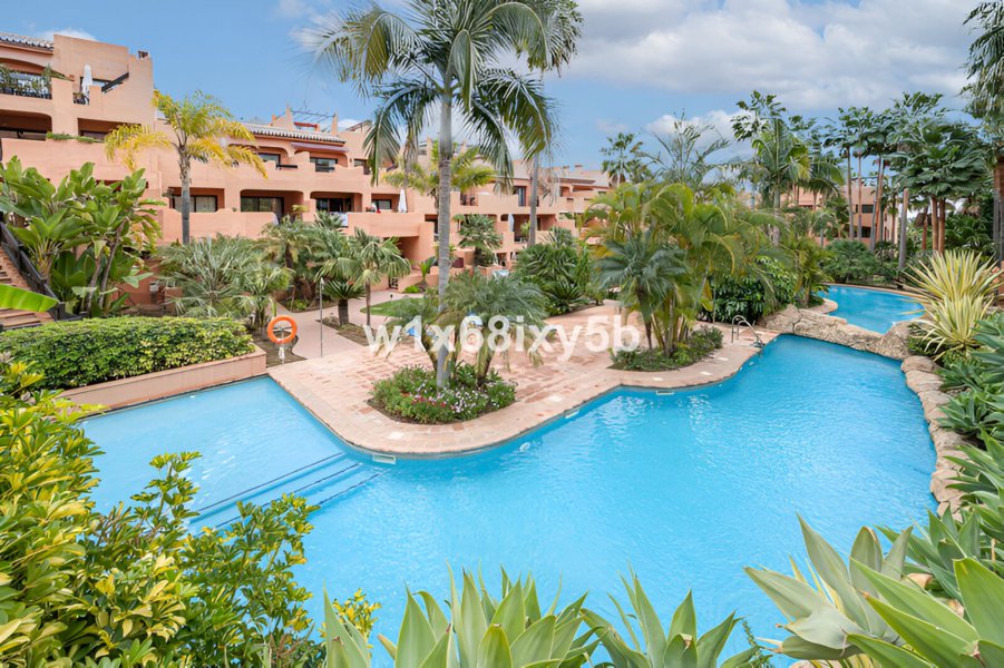 a pool with palm trees and buildings